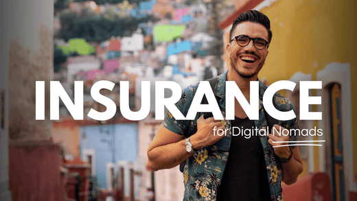 Digital nomad smiling in a colourful village set, knowing if anything happens he's covered by the best digital nomad insurance provider.